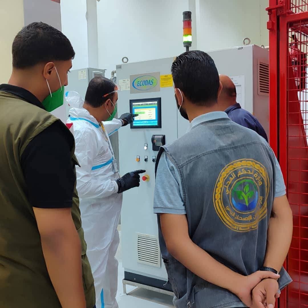 The operating team and a supervisory committee at the treatment unit control panel.